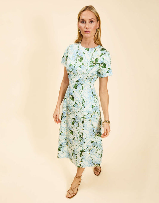 Woman wearing a floral dress on a beige background
